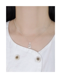 Macro shot of S925 sterling silver necklace with irregular hollow star pendant on a model