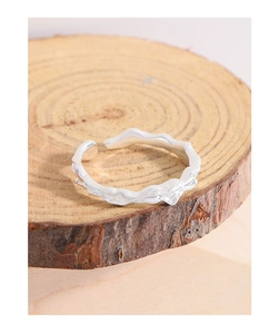 Detailed close-up of S925 silver ring featuring organic lava texture on a wooden stand