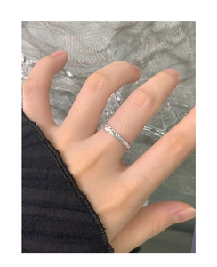 Macro view of S925 sterling silver ring featuring irregular molten lava texture detail