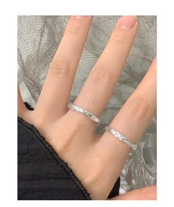 Close-up of S925 sterling silver lava texture rings with zircon stones on finger