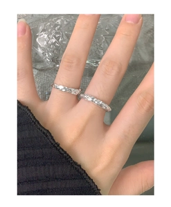 Detailed view of S925 sterling silver ring with organic lava texture on model finger