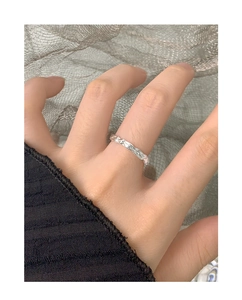 Detailed macro view of S925 sterling silver ring with molten lava texture and metallic luster