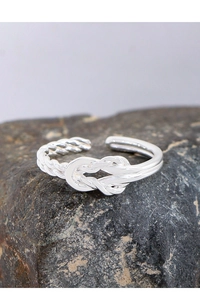 Detailed view of S925 sterling silver twisted rope ring with a knot design on stone