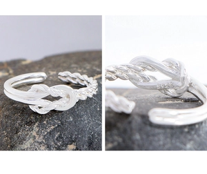 Detailed view of S925 sterling silver stamp on the twisted knot adjustable ring band