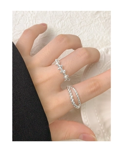 Close-up of S925 sterling silver bow and double-layer twisted rope rings on a model