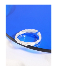 Macro shot of S925 sterling silver ring showing irregular lava texture and hallmark