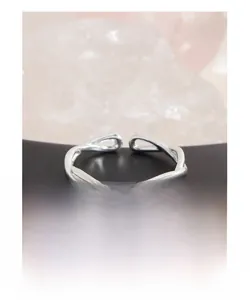 Detail of twisted cross hollow ring in S925 sterling silver with adjustable open design