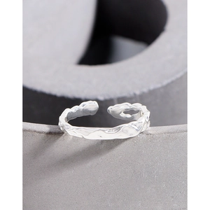Minimalist S925 sterling silver open ring with irregular lava texture on grey background