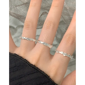 Set of three silver S925 rings with irregular lava texture finish on fingers