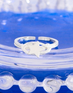 Macro view showing S925 hallmark on minimalist silver star and planet open ring