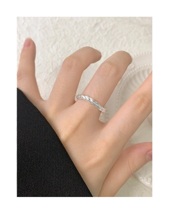 Close-up of minimalist S925 sterling silver twisted rope ring worn on a finger