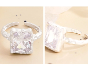 Macro detail of S925 sterling silver ring with square zircon and lava texture finish