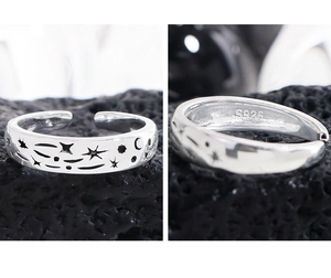 Macro shot of S925 sterling silver ring showing engraved stars, moon, and hallmark stamp