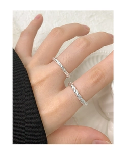 Detail of S925 sterling silver twist ring and star engraved band for women