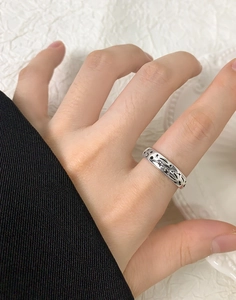 Detail of S925 sterling silver ring featuring engraved black star and moon patterns