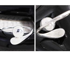 Macro shot of S925 sterling silver stamp on minimalist polished drop ball open ring