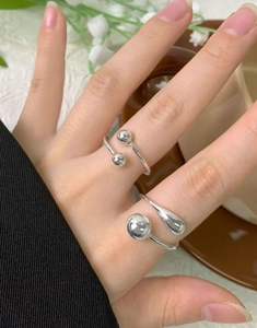Close-up of S925 sterling silver open rings with geometric sphere and teardrop design