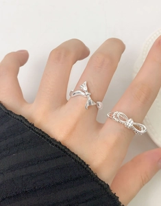 Close-up of S925 sterling silver double-layer bow rings on a model's hand