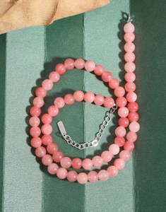 Detailed macro of S925 silver clasp on a natural pink agate beaded necklace