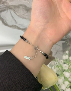 Detail of S925 sterling silver beads bracelet with black agate beads on female wrist