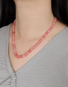 On-body view of a pink agate beaded necklace crafted from 925 sterling silver