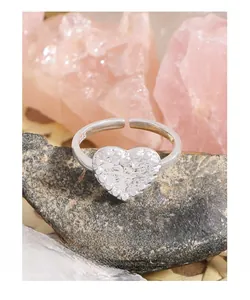 Macro shot of S925 sterling silver heart ring with lava texture on volcanic stone