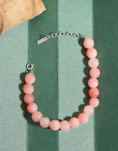 Detail of S925 sterling silver lobster clasp and tag on pink agate beaded bracelet