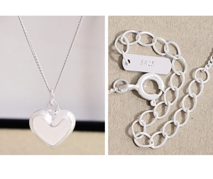Macro detail of S925 sterling silver heart necklace clasp and hallmark engraving