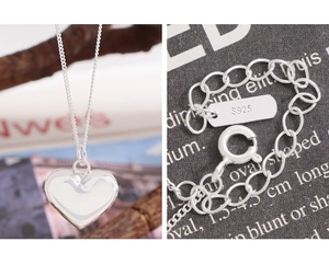 Macro shot of S925 sterling silver heart pendant necklace with spring ring clasp detail