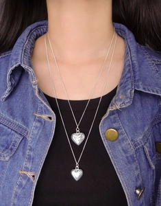 Close-up of a double-layered S925 sterling silver long necklace with heart pendants