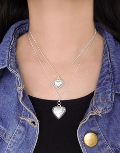 Close-up of double-layer S925 silver heart necklace worn with denim jacket