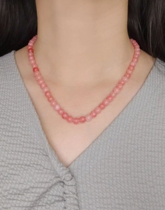 Detail shot of natural pink agate beaded necklace on model with 925 silver clasp