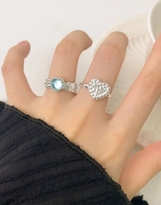 Detailed view of S925 silver ring set with blue heart gem and sparkling zircon pave
