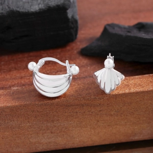 Elegant S925 sterling silver shell pearl earrings on a natural wooden display