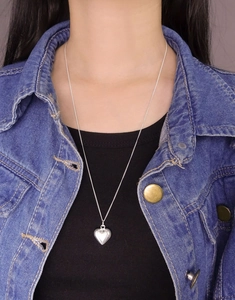 Close-up of S925 sterling silver heart pendant necklace worn on a black sweater
