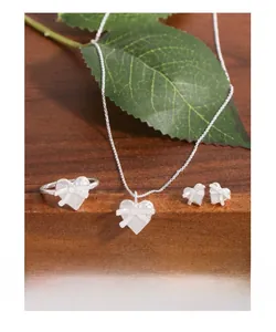Detailed view of S925 sterling silver heart jewelry set with matte finish and 3D bow design