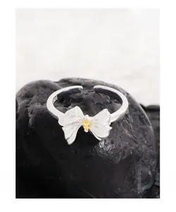 Macro view of S925 sterling silver bow ring with yellow marquise zircon on stone