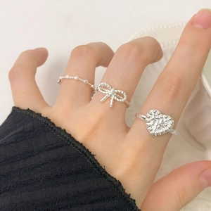 S925 sterling silver heart ring set with lava texture and bow design on finger