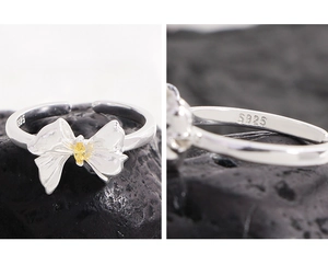 Macro detail of S925 sterling silver ring with yellow marquise zircon bow design