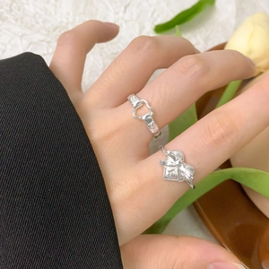 S925 sterling silver heart and bow rings on finger with elegant minimalist design