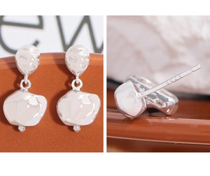 Close-up of S925 hallmark on irregular molten texture silver earrings for women