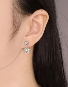Macro view of S925 sterling silver earrings with irregular liquid metal texture worn on ear