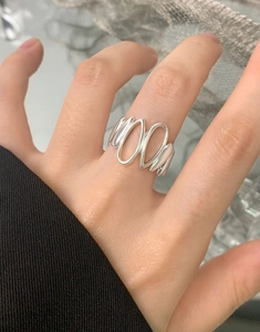 Detail shot of a minimalist S925 sterling silver irregular drop ring worn on finger