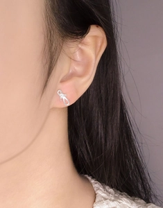 Detail of S925 sterling silver bowknot stud earring on ear with high-gloss finish