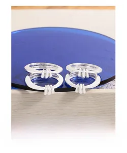Detailed view of two interlocking S925 silver rings with vertical triple-line design on a base