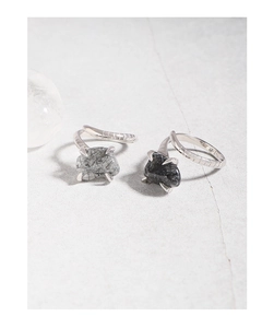 Macro view of S925 silver snake-shaped ring featuring natural black rutilated quartz