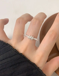 Close-up of S925 sterling silver triple spiral ring on finger with elegant aesthetic