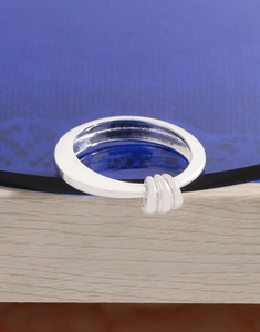 Macro shot of S925 sterling silver ring with three hanging moving metal loops