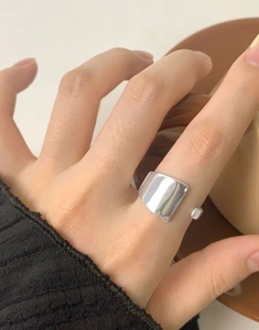 Macro detail of silver S925 geometric irregular ring with polished mirror finish