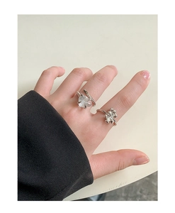 Detail of silver S925 rings featuring natural rutilated quartz and liquid metal style